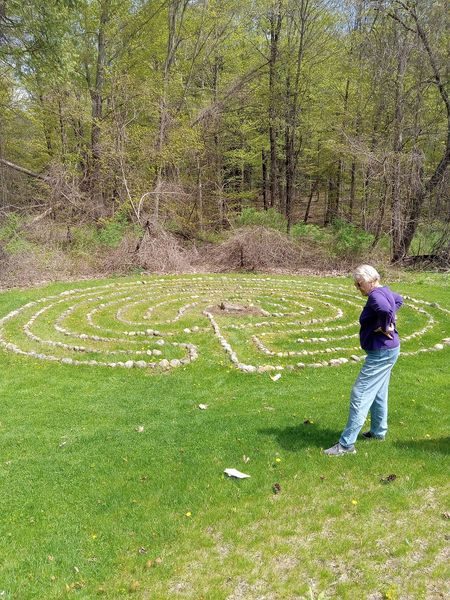 Gardener next to a stone labyrinth