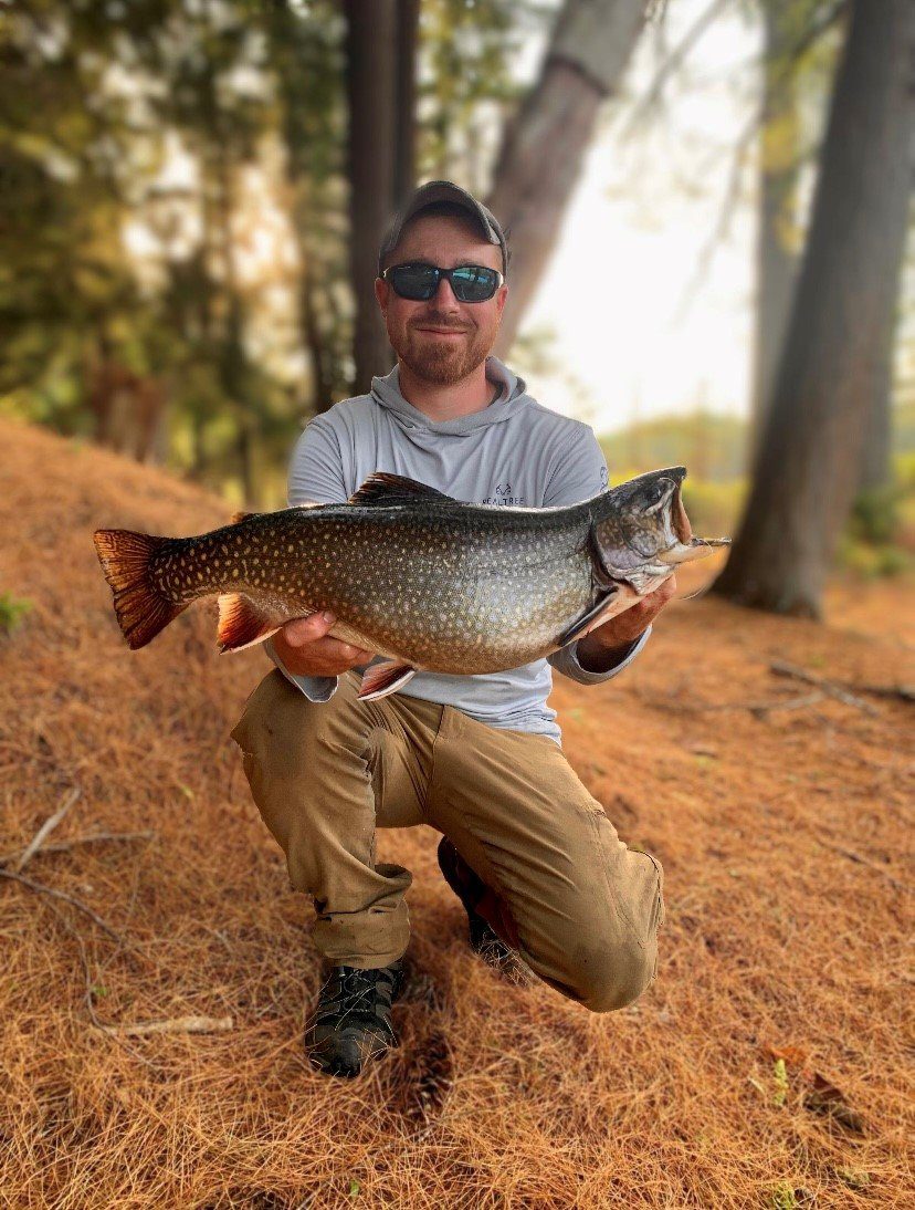 man holds up record breaking fish